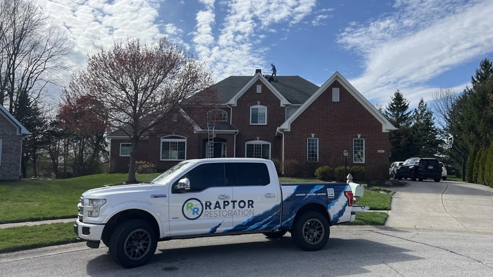 Raptor Roofing truck at a residential project